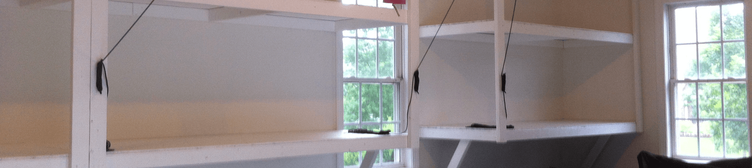 a remodeled garage that features shelving and a bike rack