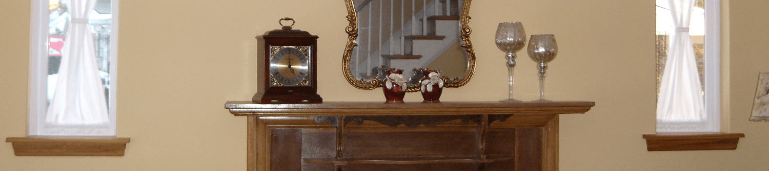 a restored living room with fireplace and accent windows